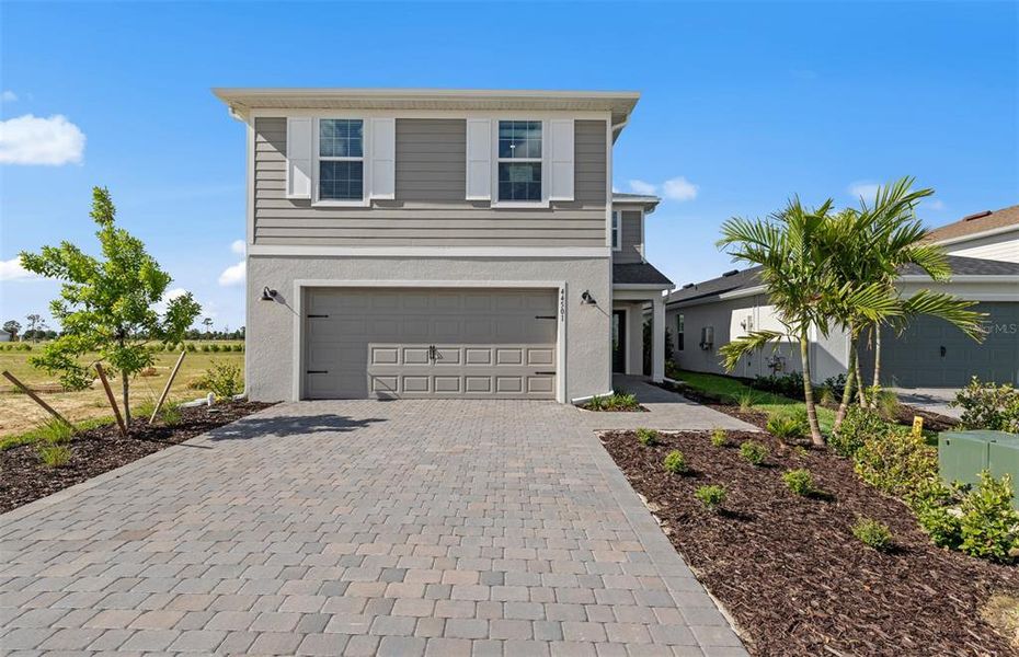 Front exterior of a new home in Reagan Landing, Bradenton, FL, highlighting curb appeal (Image 1). Front exterior of a new home in Reagan Landing, Bradenton, FL, highlighting curb appeal (Image 1).