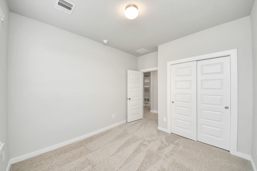 Generously sized secondary bedrooms featuring spacious closets, soft and inviting carpeting underfoot, large windows allowing plenty of natural light, and the added touch of privacy blinds for your personal retreat. Sample photo of completed home with similar floor plan. Actual colors and selections may vary. Generously sized secondary bedrooms featuring spacious closets, soft and inviting carpeting underfoot, large windows allowing plenty of natural light, and the added touch of privacy blinds for your personal retreat. Sample photo of completed home with similar floor plan. Actual colors and selections may vary.