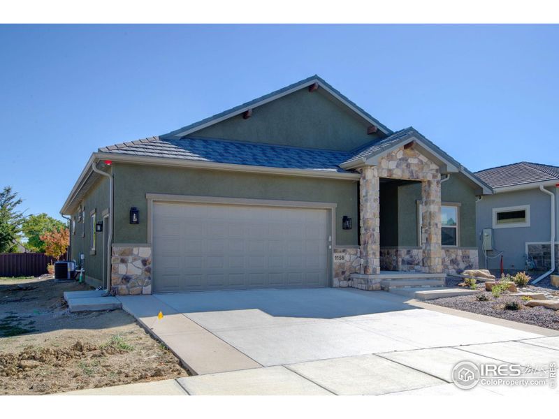 Front exterior of a new home in , Loveland, CO, highlighting curb appeal (Image 1).