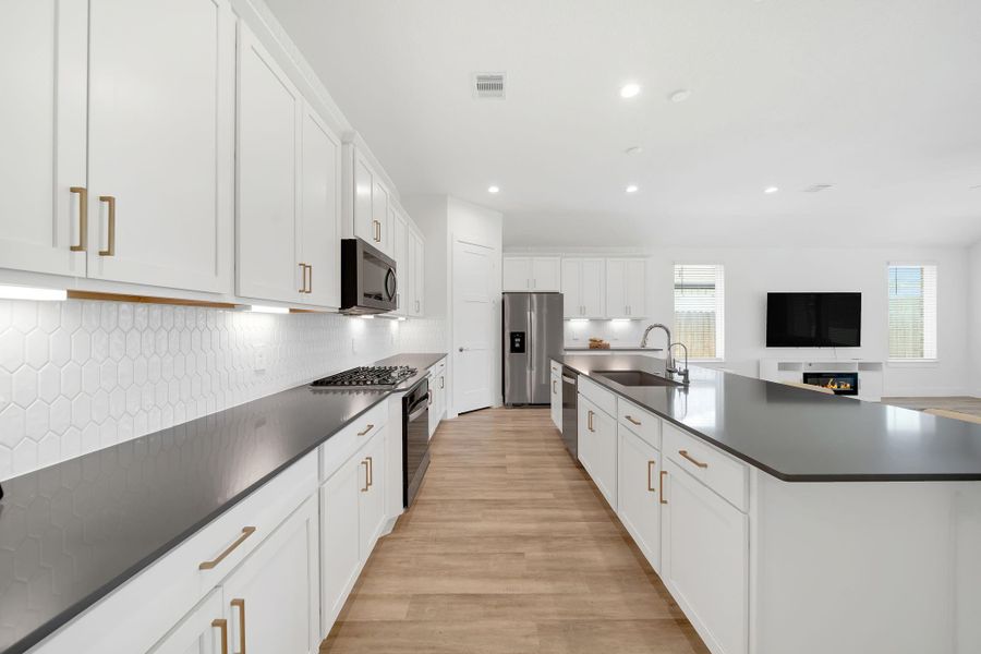 This kitchen is a dream come true for any chef, offering ample counter space for meal preparation and 42-inch cabinets that provide abundant storage.