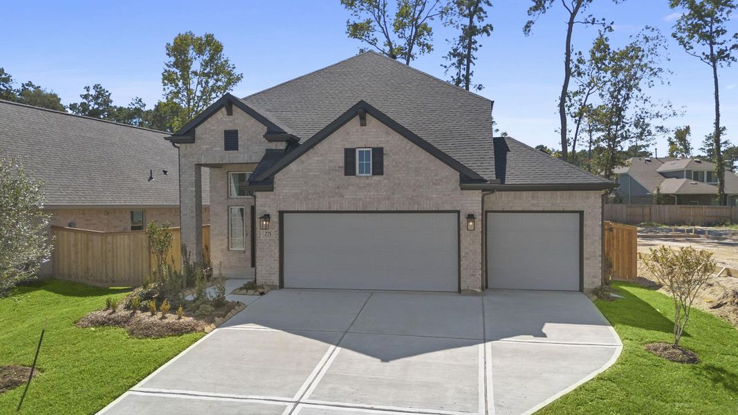 Front exterior of a new home in The Woodlands Hills, Willis, TX, highlighting curb appeal (Image 18). Front exterior of a new home in The Woodlands Hills, Willis, TX, highlighting curb appeal (Image 18).