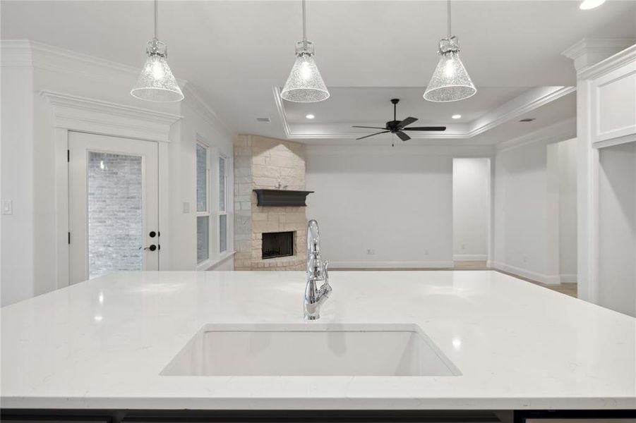 Kitchen with pendant lighting, a spacious island, and sink