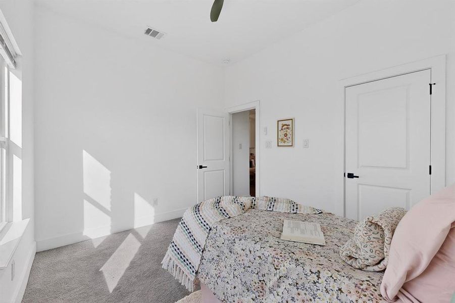 Bedroom with light carpet and ceiling fan