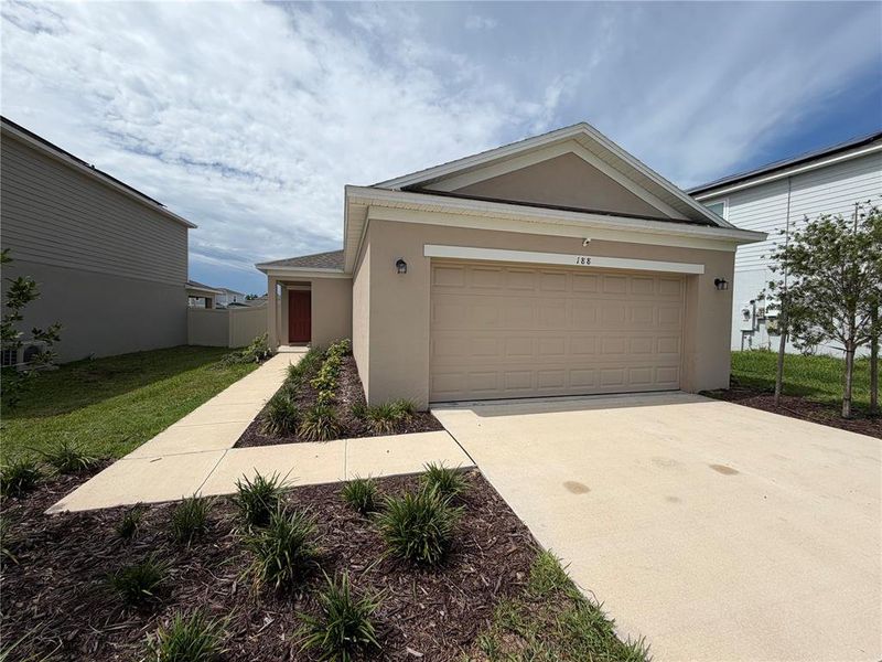 Front exterior of a new home in Marion Creek, Haines City, FL, highlighting curb appeal (Image 25).