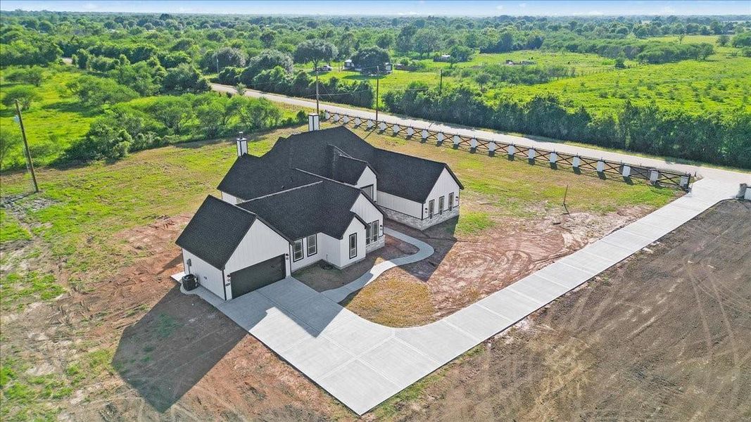 Aerial view highlighting the home, surrounding acreage, and peaceful setting. Aerial view highlighting the home, surrounding acreage, and peaceful setting.