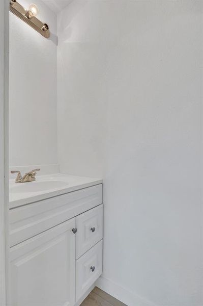 Bathroom featuring vanity and light wood finished floors