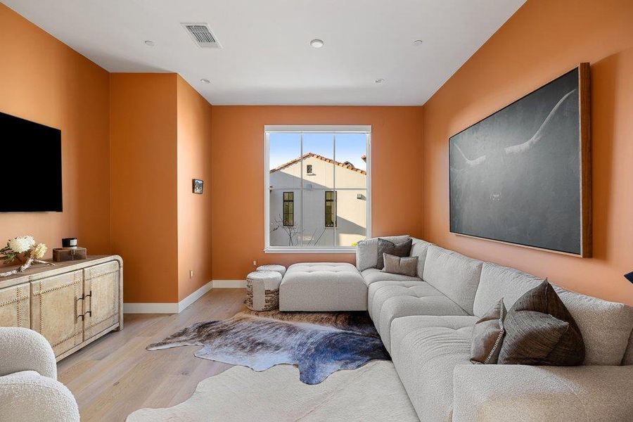 Living area featuring light wood-type flooring and baseboards