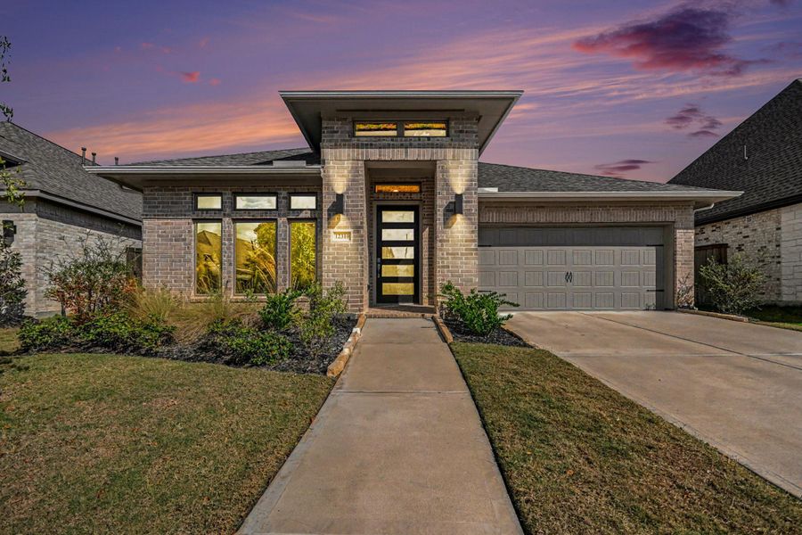 Front exterior of a new home in Riceland 50', Mont Belvieu, TX, highlighting curb appeal (Image 2). Front exterior of a new home in Riceland 50', Mont Belvieu, TX, highlighting curb appeal (Image 2).