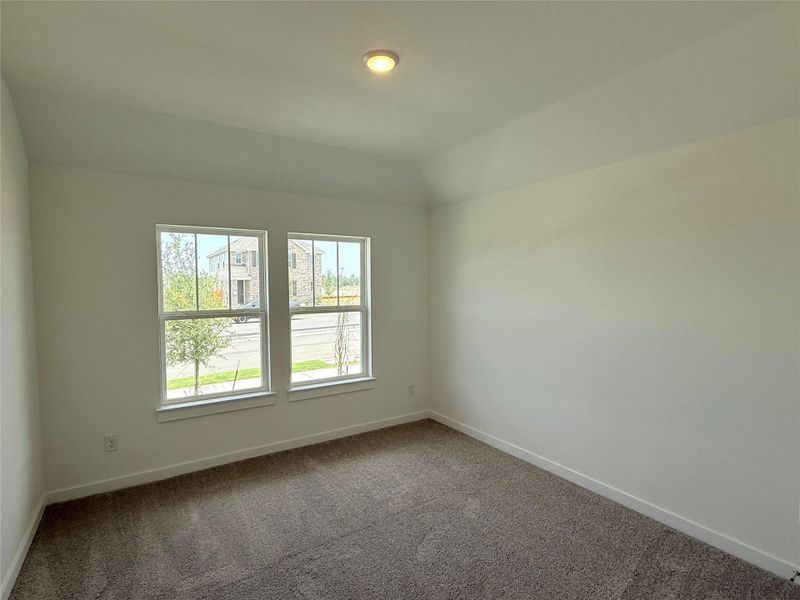 Spare room featuring carpet and baseboards