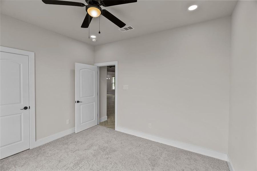 Unfurnished bedroom with carpet, baseboards, recessed lighting, and ceiling fan