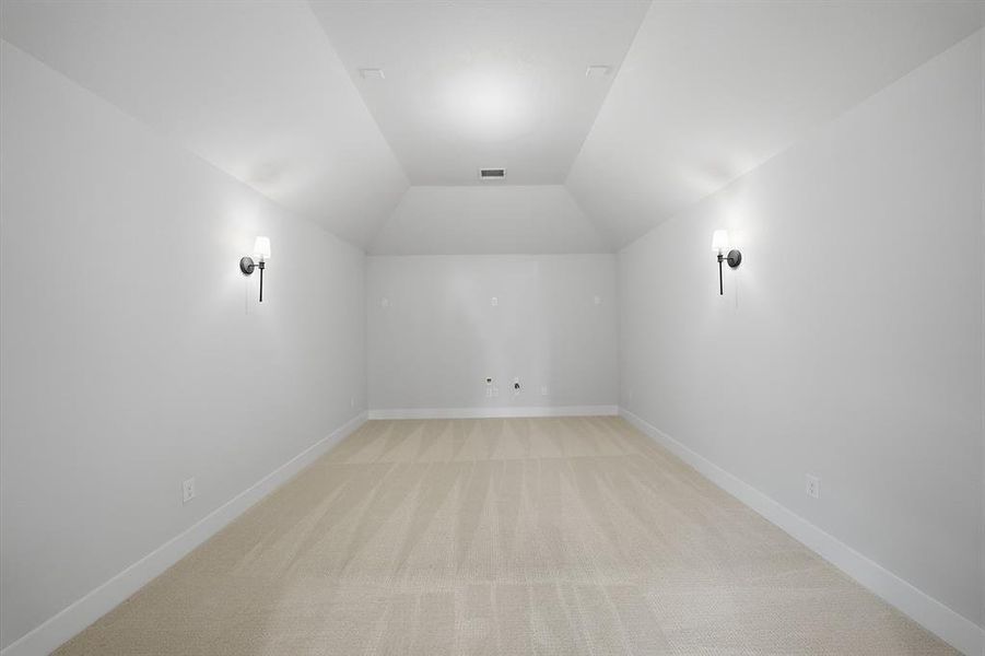 Bonus room featuring light carpet and lofted ceiling
