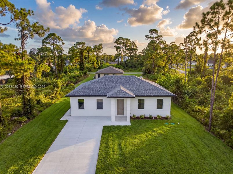 Front exterior of a new home in , Lehigh Acres, FL, highlighting curb appeal (Image 24).