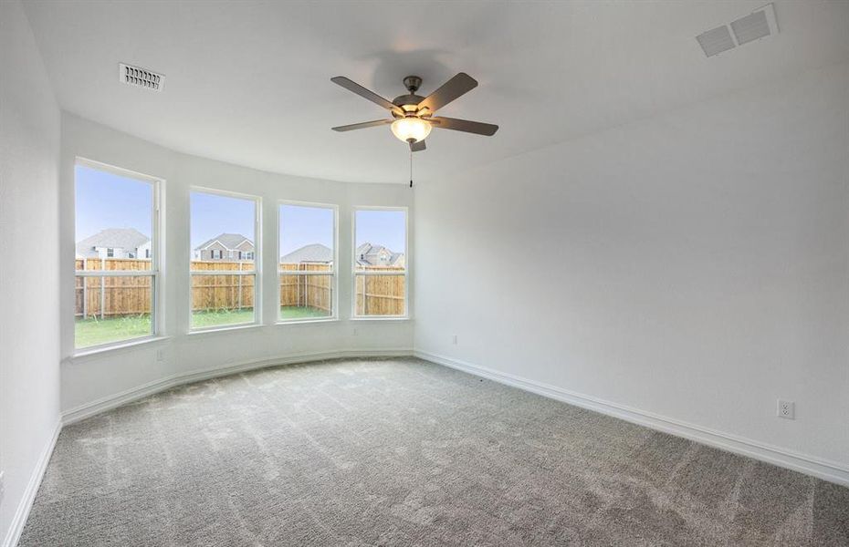 Elegant owner's suite with bay window *real home pictured