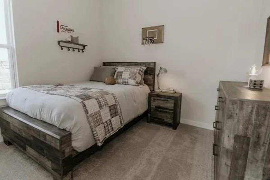 Bedroom with baseboards and light colored carpet Bedroom with baseboards and light colored carpet