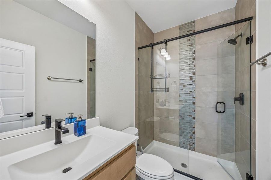 Bathroom with vanity and a shower stall