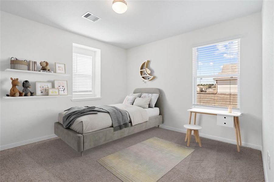 This secondary bedroom features high ceilings, custom paint, plush carpet, and large windows with privacy blinds!