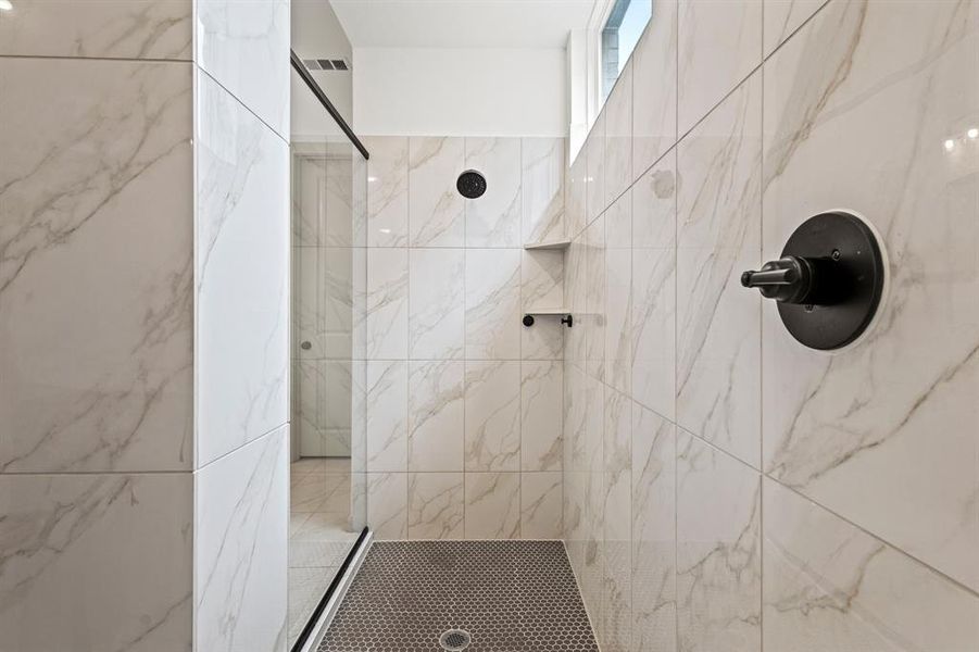 Bathroom featuring a marble finish shower