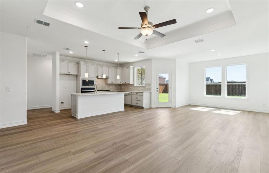 Open concept gathering room creating a spacious and inviting atmosphere *Real home pictured Open concept gathering room creating a spacious and inviting atmosphere *Real home pictured