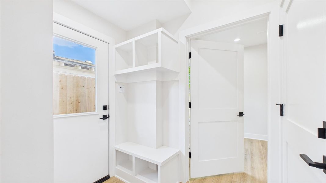 Step into convenience with this sleek mudroom, perfectly positioned at the garage entry for seamless organization and style.
