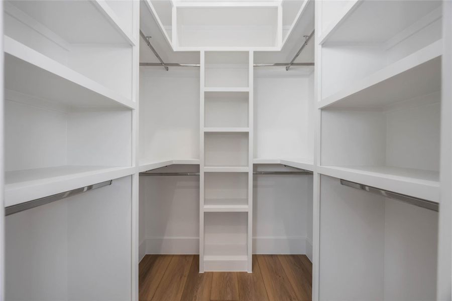Custom-built primary closet with tailored shelving and hanging space for effortless organization.
