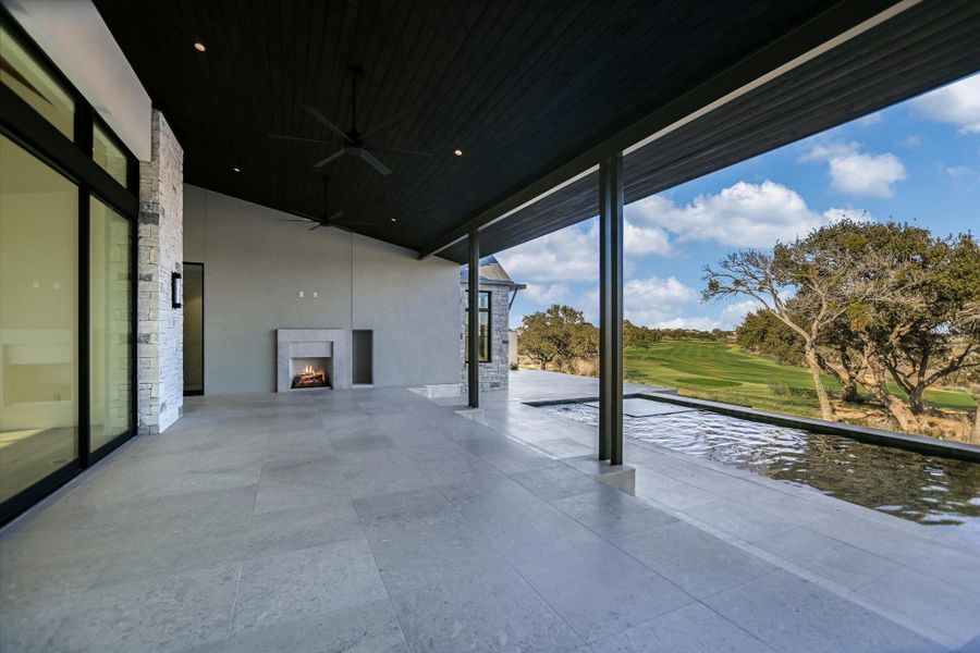 View of patio / terrace with a ceiling fan and golf course view