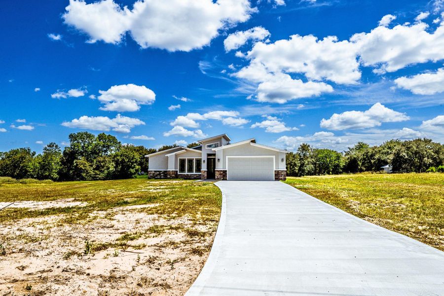 Front exterior of a new home in , Huntsville, TX, highlighting curb appeal (Image 19).