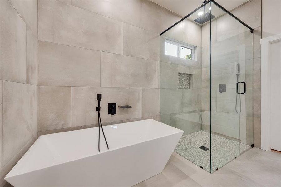 Bathroom with tile walls and shower with separate bathtub