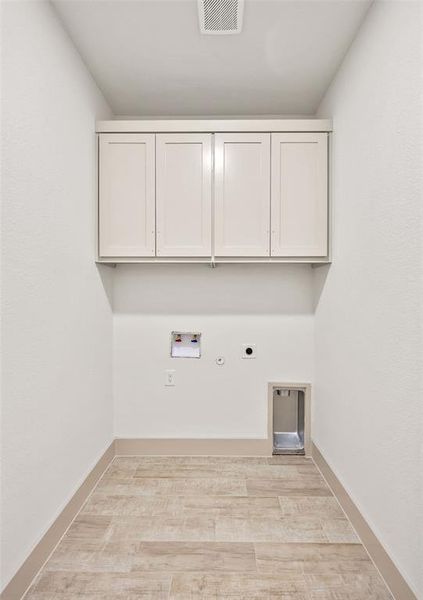 Washroom featuring hookup for an electric dryer, hookup for a washing machine, gas dryer hookup, cabinet space, and light wood-type flooring