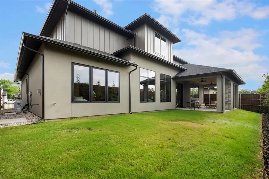 Back of house featuring a fenced backyard, a patio, ceiling fan, and stucco siding Back of house featuring a fenced backyard, a patio, ceiling fan, and stucco siding