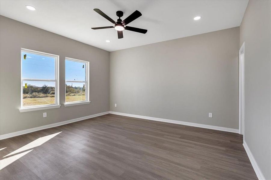 Empty room with dark wood finished floors, recessed lighting, and ceiling fan