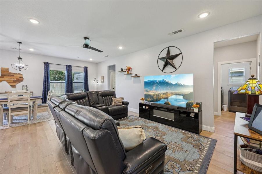 Living area featuring recessed lighting, light wood-type flooring, ceiling fan, and a chandelier Living area featuring recessed lighting, light wood-type flooring, ceiling fan, and a chandelier