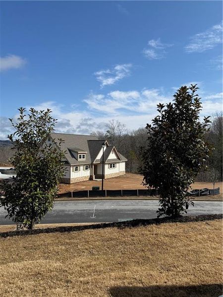 Front exterior of a new home in Somerset at Riverbrook, Gainesville, GA, highlighting curb appeal (Image 2). Front exterior of a new home in Somerset at Riverbrook, Gainesville, GA, highlighting curb appeal (Image 2).