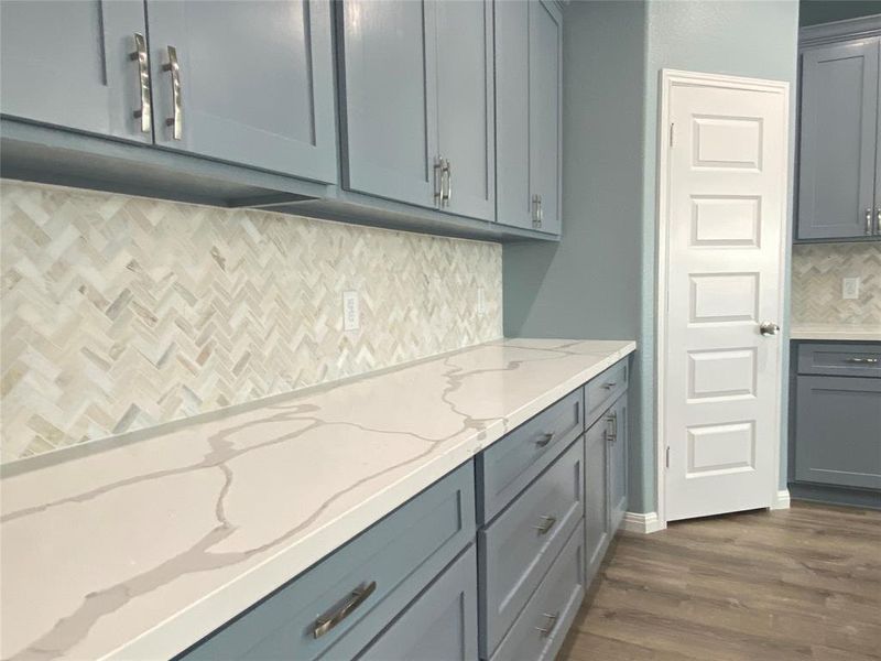 Herringbone tile backsplash and light-toned countertops grace this well-appointed kitchen. Herringbone tile backsplash and light-toned countertops grace this well-appointed kitchen.
