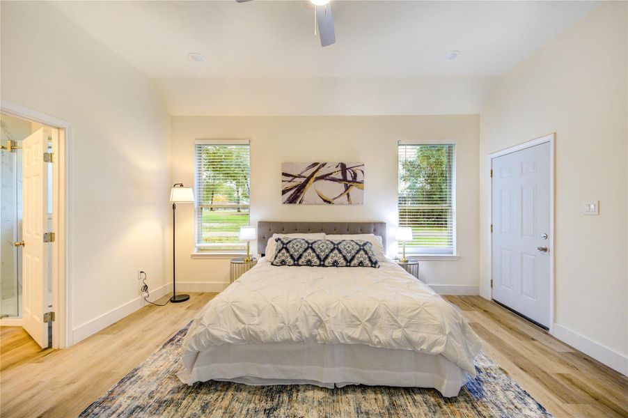 Inviting primary bedroom with ample natural light and elegant design.