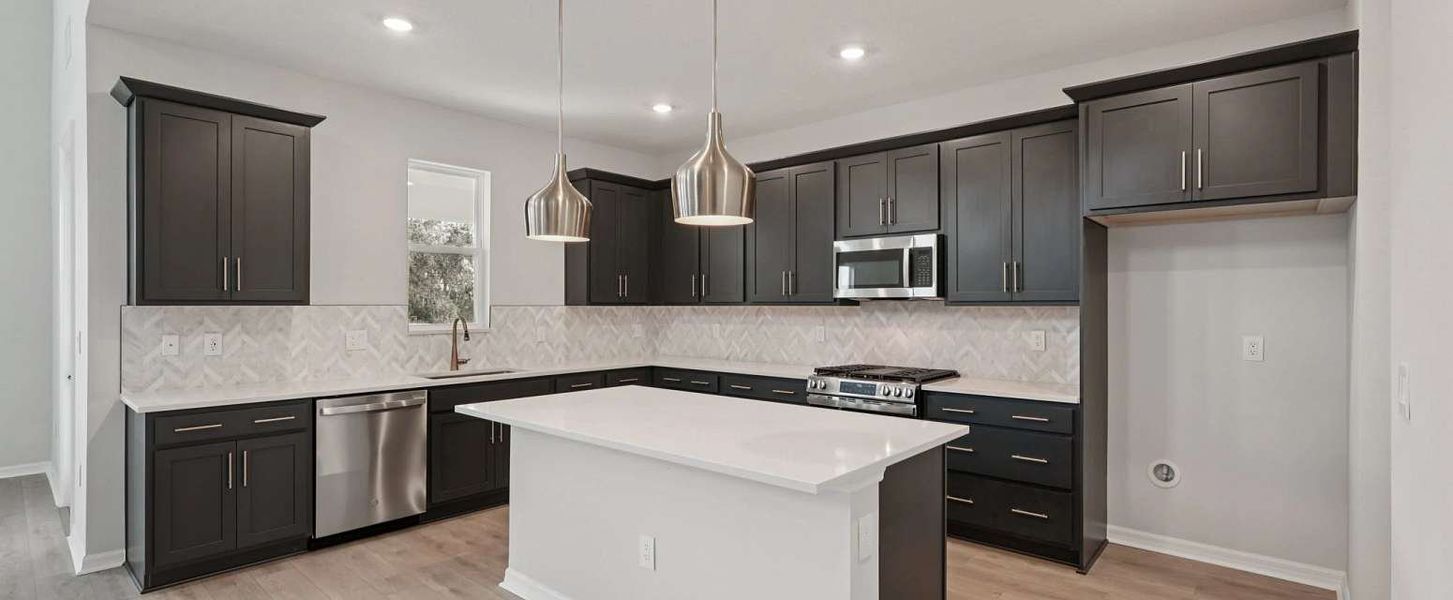 Spacious kitchen layout featuring a large island - representative image this home will feature AW Collection® Laguna Spacious kitchen layout featuring a large island - representative image this home will feature AW Collection® Laguna