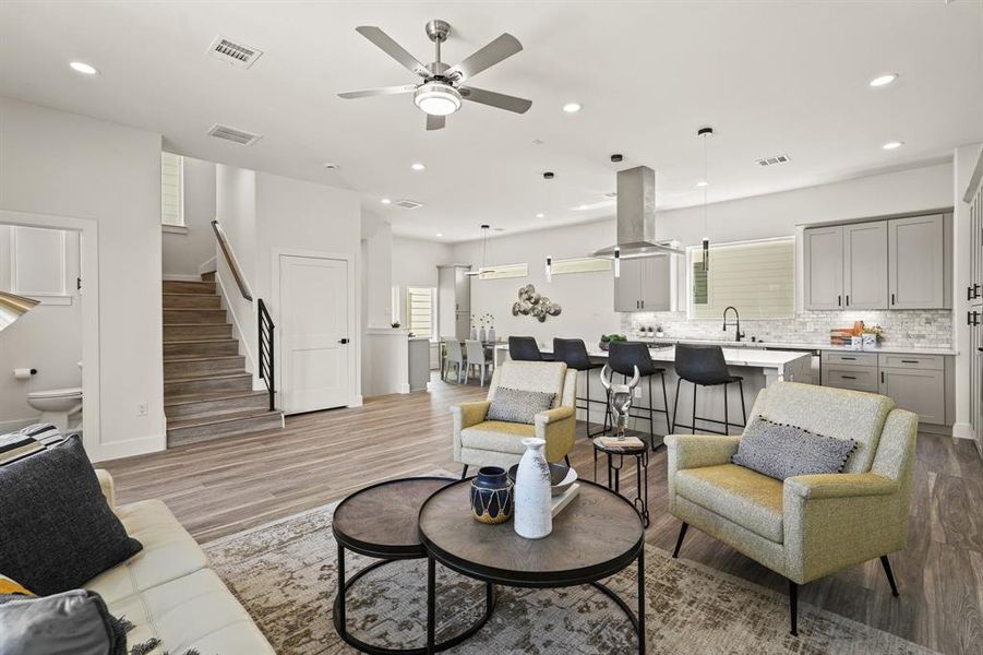 Step into luxury in this spacious living room! Natural light floods through large windows, highlighting the elegant decor and cozy atmosphere. Perfect for entertaining guests or unwinding after a long day