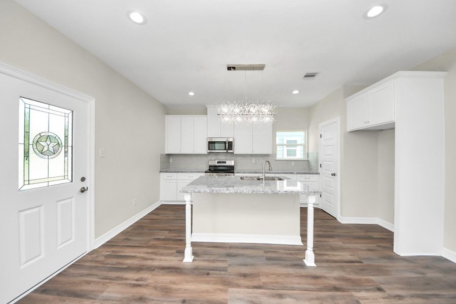 At the heart of the home, this stunning kitchen is a chef’s dream, featuring custom soft-close cabinetry, gleaming granite countertops, a spacious island with bar seating, and stainless steel appliances - (representation photo).