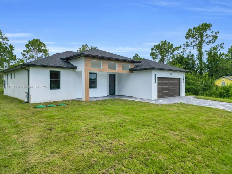 Front exterior of a new home in , Lehigh Acres, FL, highlighting curb appeal (Image 34).