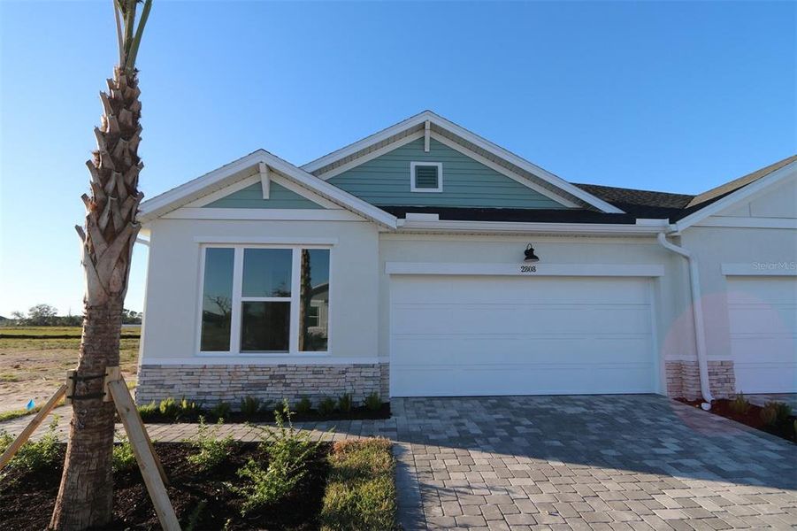 Front exterior of a new home in Gracewater at Sarasota, Sarasota, FL, highlighting curb appeal (Image 1). Front exterior of a new home in Gracewater at Sarasota, Sarasota, FL, highlighting curb appeal (Image 1).