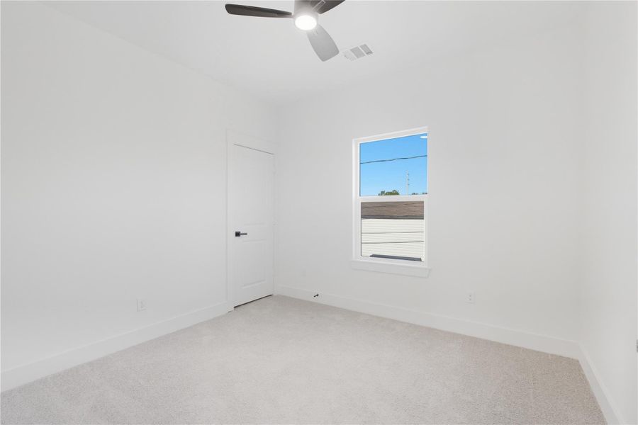 Bedroom three is filled with natural light and soft carpeting, offering a cozy space that can easily serve as a child’s room, guest space, or home office. With its clean design and modern ceiling fan, it’s a blank canvas ready to fit your needs. Bedroom three is filled with natural light and soft carpeting, offering a cozy space that can easily serve as a child’s room, guest space, or home office. With its clean design and modern ceiling fan, it’s a blank canvas ready to fit your needs.