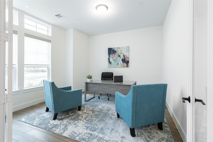 The study overlooks the front porch and pretty front yard.  This room as well as all of the rooms are prewired for wall mounted televisions.