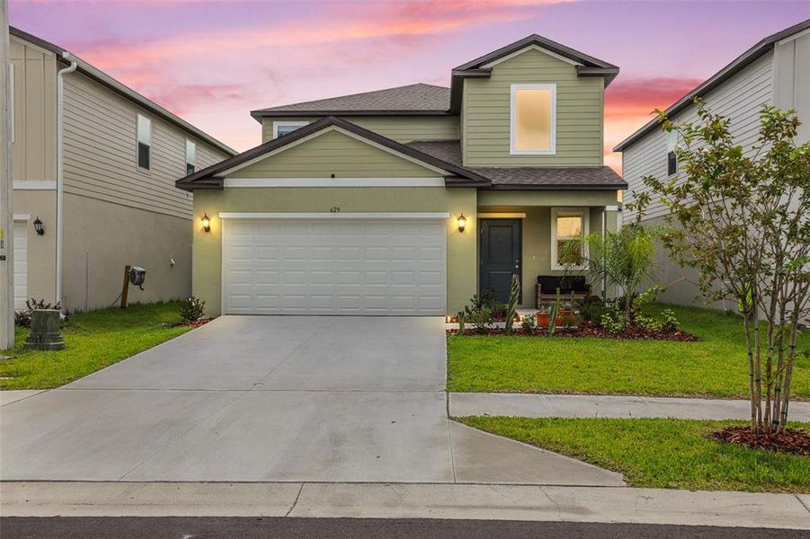 Front exterior of a new home in Cypress Point at Lake Parker, Lakeland, FL, highlighting curb appeal (Image 2).