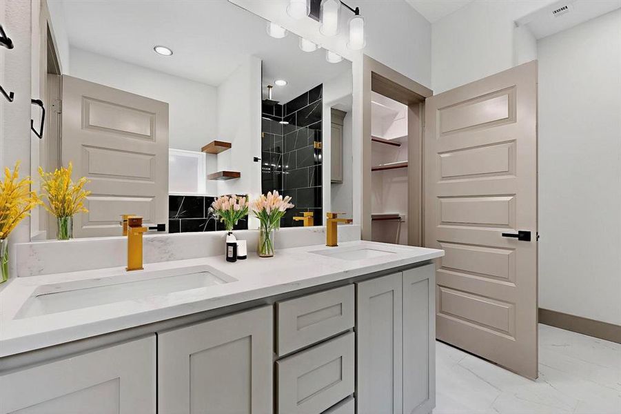 Bathroom featuring a shower stall, double vanity, light marble finish flooring, a closet, and recessed lighting