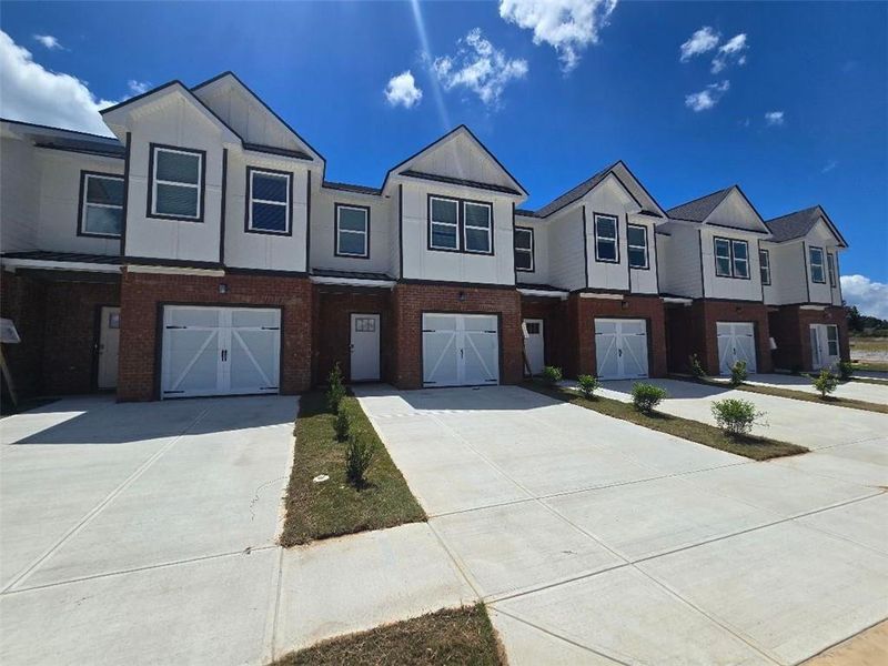 Front exterior of a new home in The Grove At Mundy Mill, Gainesville, GA, highlighting curb appeal (Image 2). Front exterior of a new home in The Grove At Mundy Mill, Gainesville, GA, highlighting curb appeal (Image 2).