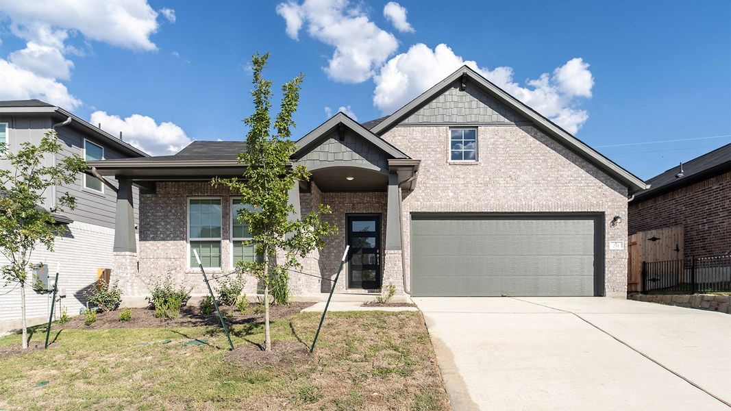 Front exterior of a new home in Sunfield, Mustang Ridge, TX, highlighting curb appeal (Image 1). Front exterior of a new home in Sunfield, Mustang Ridge, TX, highlighting curb appeal (Image 1).