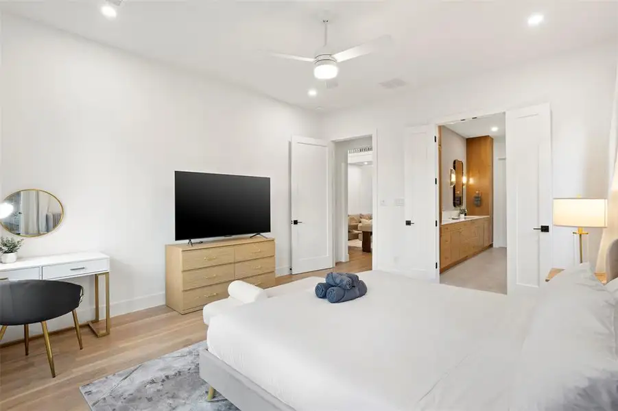 Open concept bedroom with light wood-finish flooring