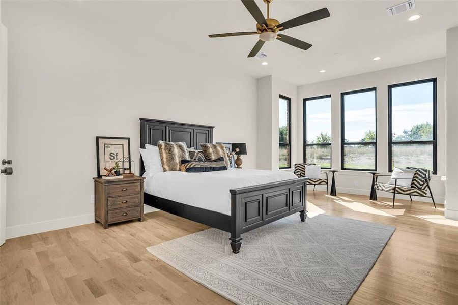 Bedroom with ceiling fan, light wood-style floors, and recessed lighting