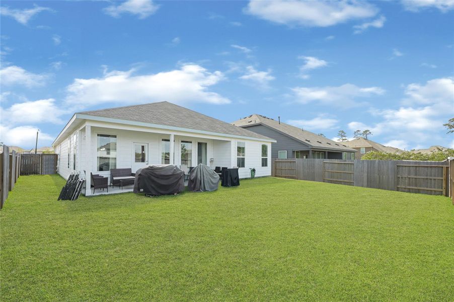 Spacious backyard with a modern patio and privacy fencing, perfect for outdoor entertaining and relaxation. Spacious backyard with a modern patio and privacy fencing, perfect for outdoor entertaining and relaxation.