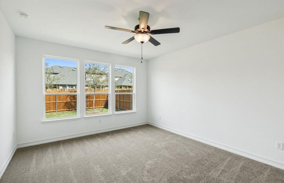 Elegant owner's suite with large windows *real home pictured