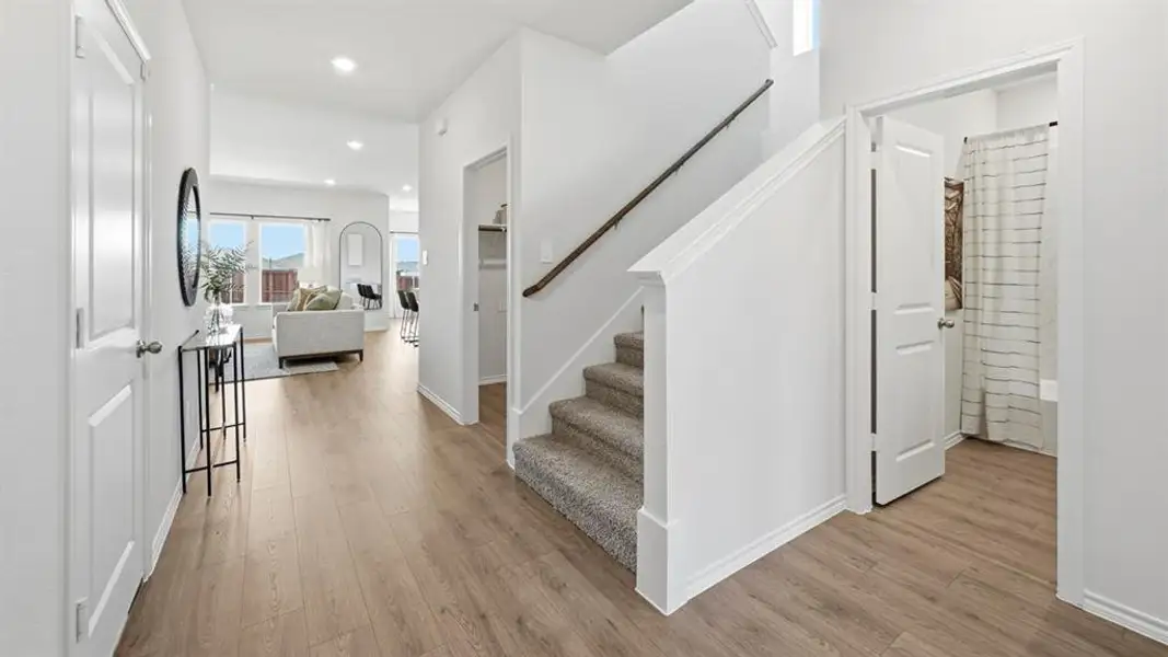 Stairway featuring wood finished floors and recessed lighting Stairway featuring wood finished floors and recessed lighting
